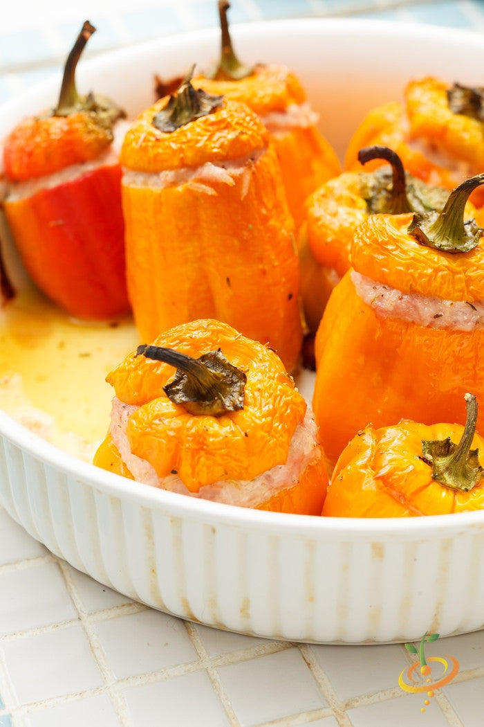Sweet orange King pepper seeds from SeedsNow, showing vibrant orange peppers and lush green foliage in the garden.